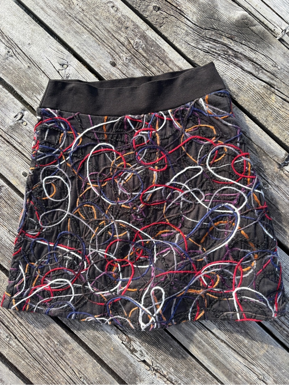 Super cute art- to-wear mini skirt with scribbled yarn embroidery in sz Medium.